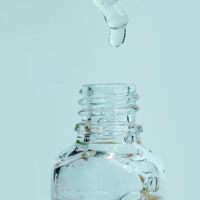Muscimol Isolate Wholesale homepage  Glass dropper bottle with a drop of liquid on a light blue background