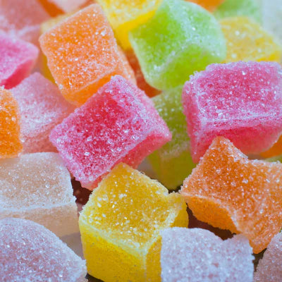 Muscimol Isolate Close-up of colorful gummy candies with a sugary texture.