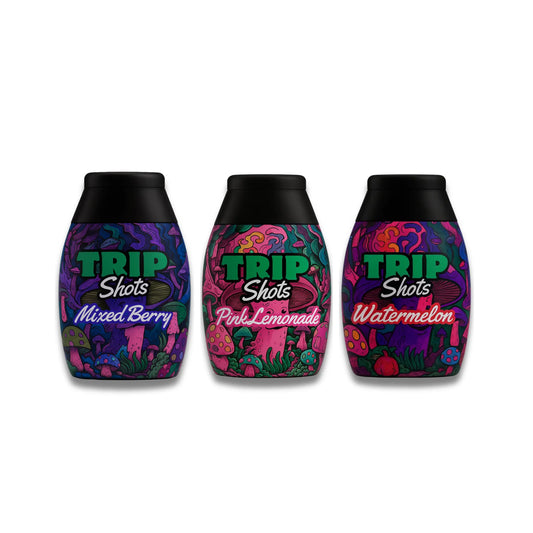 Three 'Trip Shots' bottles with colorful labels on a white background